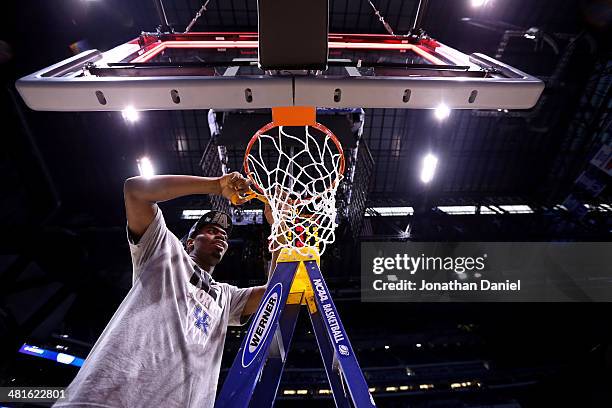 Alex Poythress of the Kentucky Wildcats cuts the net after defeating the Michigan Wolverines 75 to 72 in the midwest regional final of the 2014 NCAA...