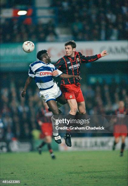 English footballers Rufus Brevett , of Queens Park Rangers, and Chris Sutton of Blackburn Rovers jumping for the ball during a Premier League match...