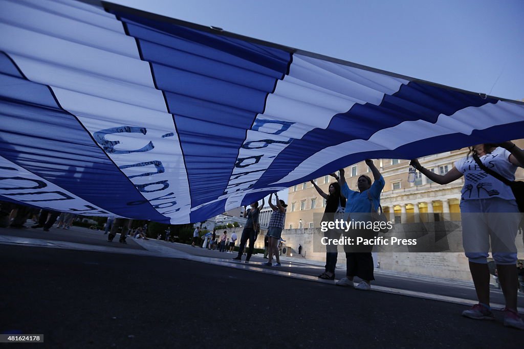 Protesters carry a large Greek Flag outside the Greek...