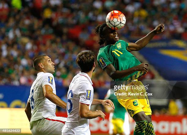 Darren Mattocks of Jamaica wins a header against Clint Dempsey and Brad Evans of the United States of America during the 2015 CONCACAF Golf Cup...