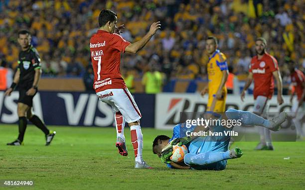 Nahuel Guzman of Tigres, catches the ball while Nilmar of Internacional tries to score during a semifinal second leg match between Tigres UANL and...