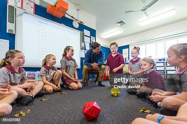 maths game being played by children in the classroom - male child playing stock pictures, royalty-free photos & images