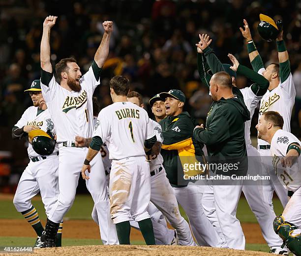 Ike Davis of the Oakland Athletics celebrates a win after an official review in the tenth inning against the Toronto Blue Jays at O.co Coliseum on...