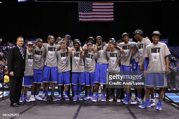 The Kentucky Wildcats celebrate after defeating the Michigan Wolverines 75 to 72 in the midwest regional final of the 2014 NCAA Men's Basketball...