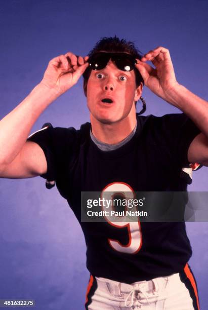 American football player Jim McMahon, quarterback for the Chicago Bears, raises his sunglasses during the filming of the video for the novelty song...