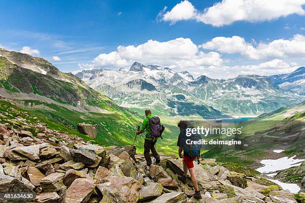 hikers explore the mountain valley - graubunden canton stock pictures, royalty-free photos & images
