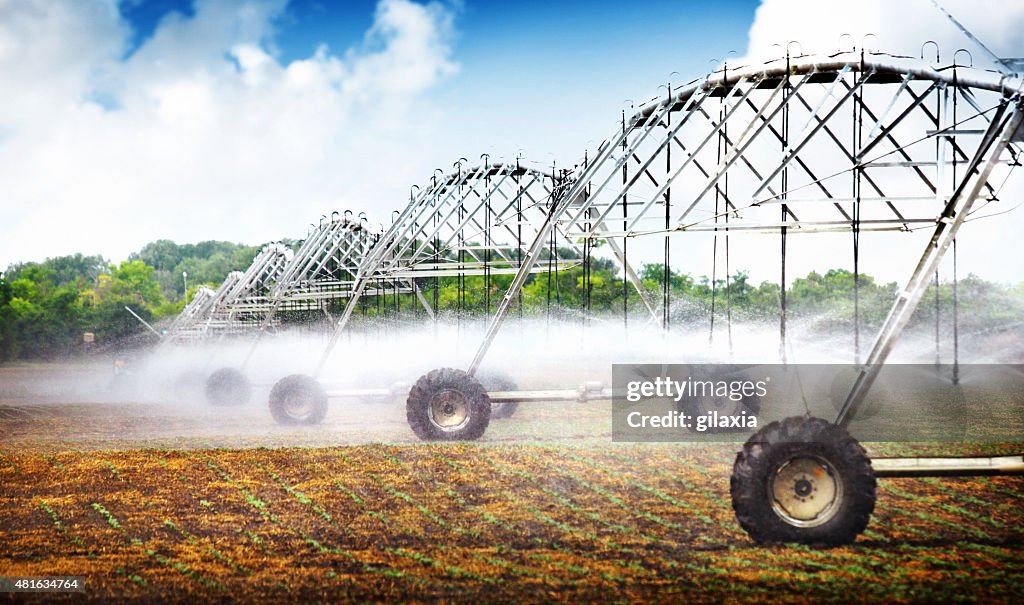 Wheeled irrigation on agricultural soil.
