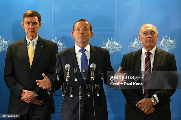 Australian Prime Minister Tony Abbott addresses the media together with former Defence Force Chief Angus Houston and Deputy Prime Minister Warren...