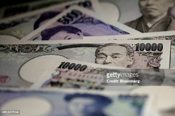 Japanese yen banknotes of various denominations are arranged for a photograph in Tokyo, Japan, on Wednesday, July 22, 2015. The yen slipped 0.1...