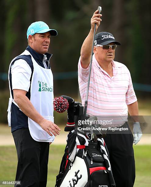 Former Australian test cricketer Shane Warne is pictured caddying for Peter O'Malley of Australia during the first round of The Senior Open...