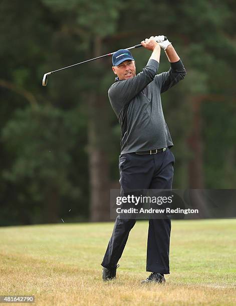 Mike Harwood of Australia plays his second shot on the second hole during the first round of The Senior Open Championship at Sunningdale Golf Club on...