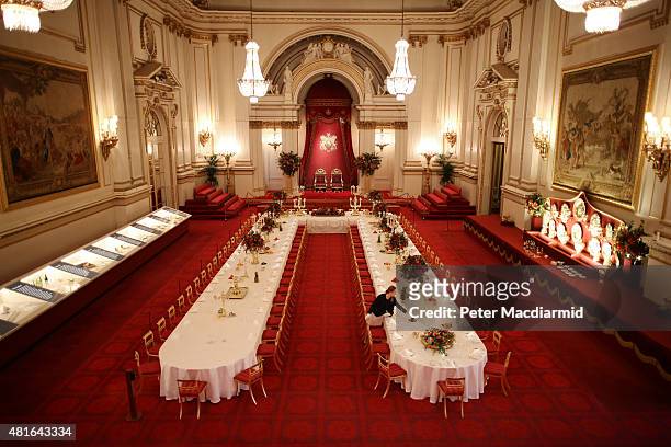 Table settings are laid out in the Palace Ballroom for a State Banquet at The Royal Welcome Summer opening exhibition at Buckingham Palace on July...