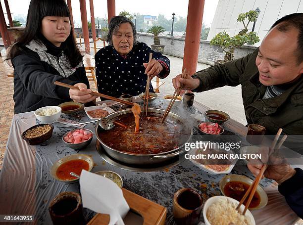 China-food-culture-lifestyle,FEATURE by Carol Huang This photo taken on February 22, 2014 shows workers enjoying hot pot food at a hot pot museum and...