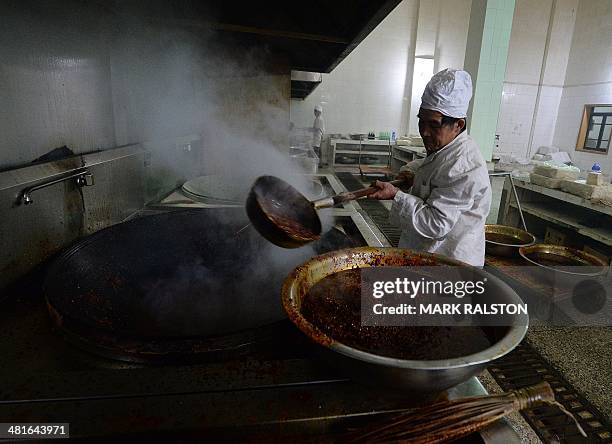 China-food-culture-lifestyle,FEATURE by Carol Huang This photo taken on February 22, 2014 shows a worker preparing hot pot sauce, made of fermented...