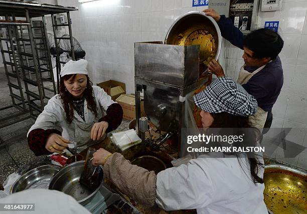 China-food-culture-lifestyle,FEATURE by Carol Huang This photo taken on February 22, 2014 shows workers preparing hot pot sauce made of fermented...