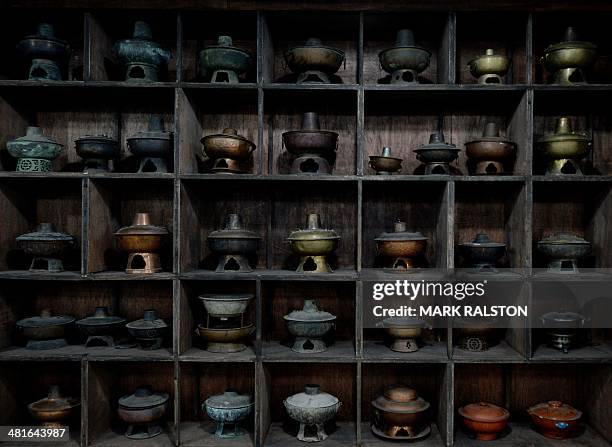 China-food-culture-lifestyle,FEATURE by Carol Huang This photo taken on February 22, 2014 shows antique hot pots at a hot pot museum and factory in...