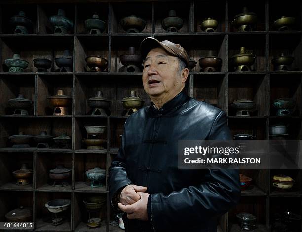 China-food-culture-lifestyle,FEATURE by Carol Huang This photo taken on February 22, 2014 shows hot pot tycoon Nie Ganru with some of his collection...