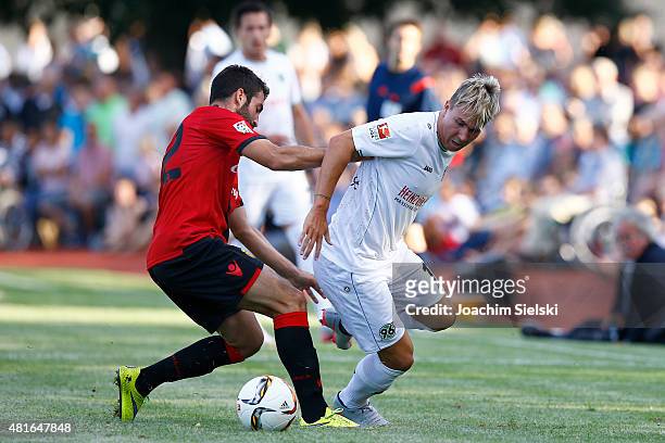 Uffe Bech of Hannover challenges Edu of Mallorca during the preseason friendly match between Hannover 96 and RCD Mallorca at Wahren-Dorff stadium on...