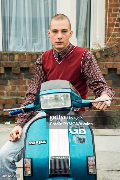 Young Skinhead, Kieron sits on T5 Vespa outside his house in Portsmouth, UK..