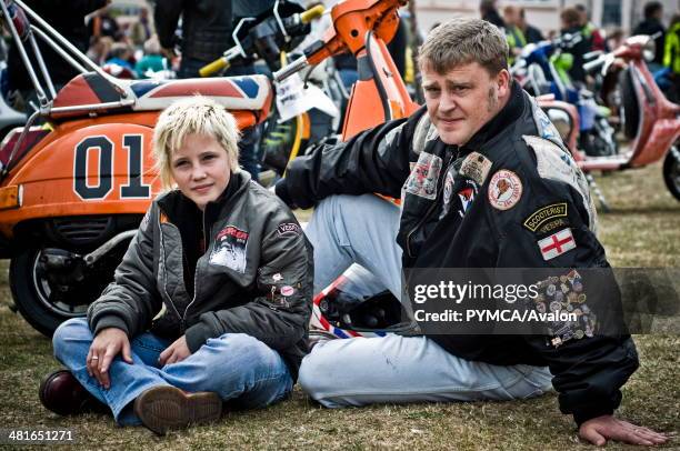 Father & his Daughter sit next to their Scooter at the Isle Of Wight Scooter Rally 2009..