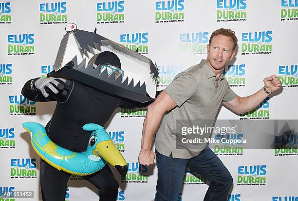 Greg T chases actor Ian Ziering as he visits "The Elvis Duran Z100 Morning Show"at Z100 Studio on July 23, 2015 in New York City.