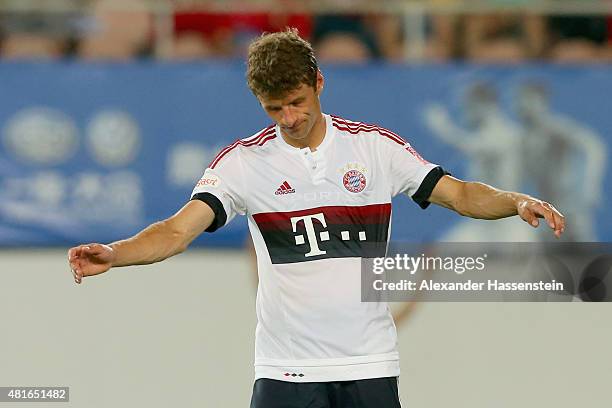 Thomas Mueller of Muenchen reacts after missed a goal at the penalty shot out of the international friendly match between FC Guangzhou Evergrande...