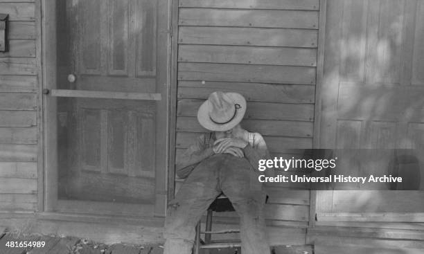 Ex-farmer resting by a house in Circleville, Ohio's "Hooverville". 1938.