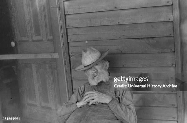 Ex-farmer resting by a house in Circleville, Ohio's "Hooverville". 1938.