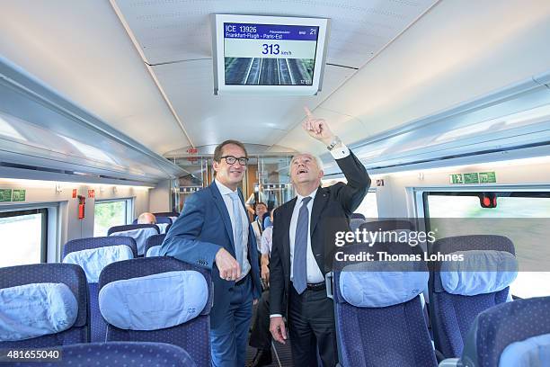 Transport and Digital Technologie Mininister Alexaner Dobrindt and Deutsche Bahn CEO Ruediger Grube look to a monitor in the new ICE 3 that shows the...