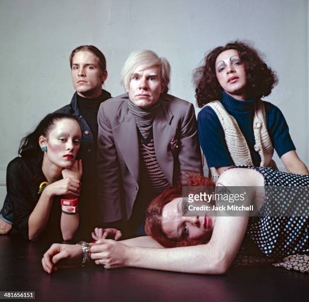 Andy Warhol photographed at the Factory with superstars Jane Forth, Jackie Curtis, Joe Dallesandro, and Holly Woodlawn.