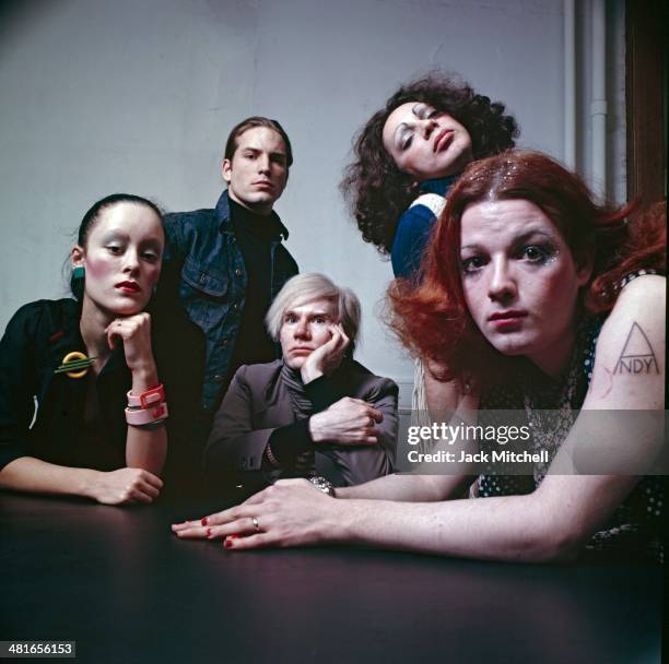 Andy Warhol photographed at the Factory with superstars Jane Forth, Jackie Curtis, Joe Dallesandro, and Holly Woodlawn.