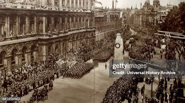 Crowds gather at Whitehall near the Cenotaph monument, in London for a victory parade 19th June 1919 to mark the peace treaty signed at Versialles...