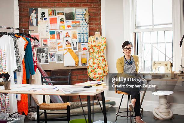 fashion designer in her studio - fashion designer table stock pictures, royalty-free photos & images