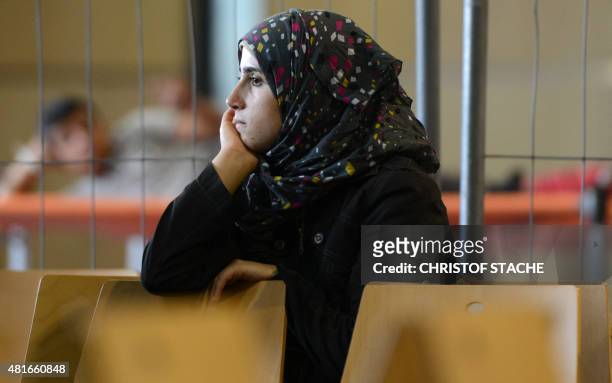 Refugee waits to be processed at the first registration point for asylum seekers of the German federation police in Passau, southern Germany, on July...
