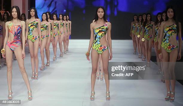 This photo taken on March 30, 2014 shows models participating in "Goldpartner the 9th China Super Model Contest Final" during the bi-annual China...