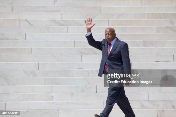 Georgia Congressman John Lewis waves at the National Action to Realize the Dream march and rally for the 50th Anniversary of the march on Washington...