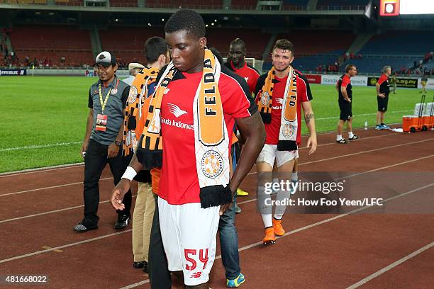 Players receiving souveniers from Felda United at the Bukit Jalil Stadium on July 23, 2015 in Kuala Lumpur, Malaysia.