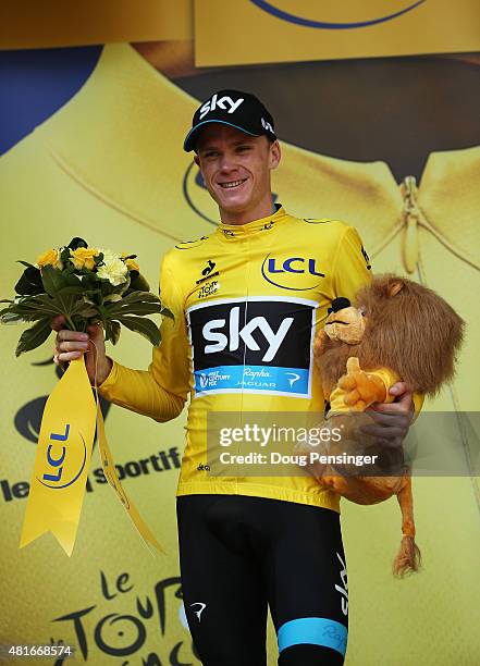 Chris Froome of Great Britain and Team Sky celebrates his overall leader yellow jersey on the podium after Stage Eighteen of the 2015 Tour de France,...