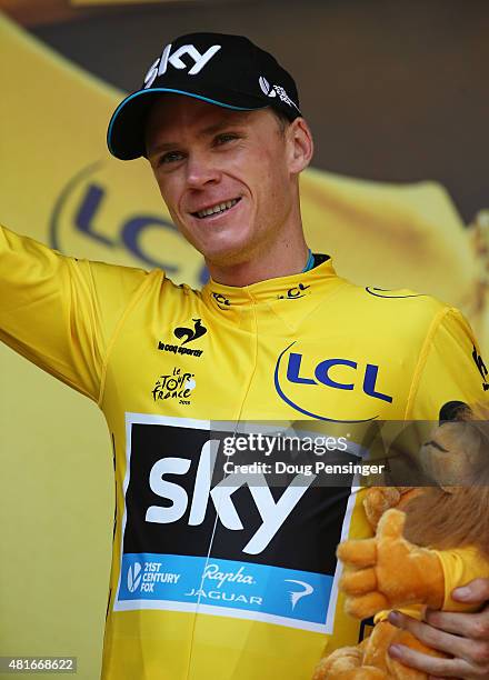 Chris Froome of Great Britain and Team Sky celebrates his overall leader yellow jersey on the podium after Stage Eighteen of the 2015 Tour de France,...