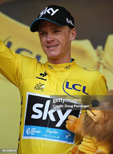 Chris Froome of Great Britain and Team Sky celebrates his overall leader yellow jersey on the podium after Stage Eighteen of the 2015 Tour de France,...