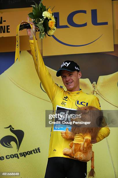 Chris Froome of Great Britain and Team Sky celebrates his overall leader yellow jersey on the podium after Stage Eighteen of the 2015 Tour de France,...