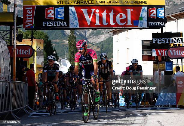 Jose Serpa of Columbia riding for Lampre-Merida leads the final group of riders across the finish line more than 35 minutes after Romain Bardet of...