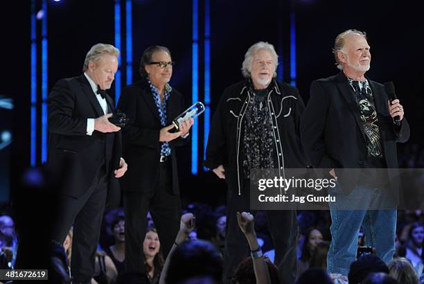 Blair Thornton, Robbie Bachman, Randy Bachman and Fred Turner receive their award at the 2014 Juno Awards held at the MTS Centre on March 30, 2014 in...