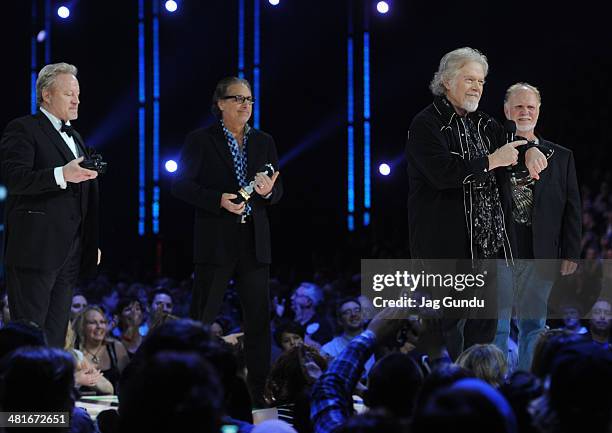 Blair Thornton, Robbie Bachman, Randy Bachman and Fred Turner receive their award at the 2014 Juno Awards held at the MTS Centre on March 30, 2014 in...