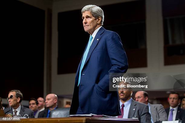 John Kerry, U.S. Secretary of state, stands up during a Senate Foreign Relations Committee hearing in Washington, D.C., U.S., on Thursday, July 23,...
