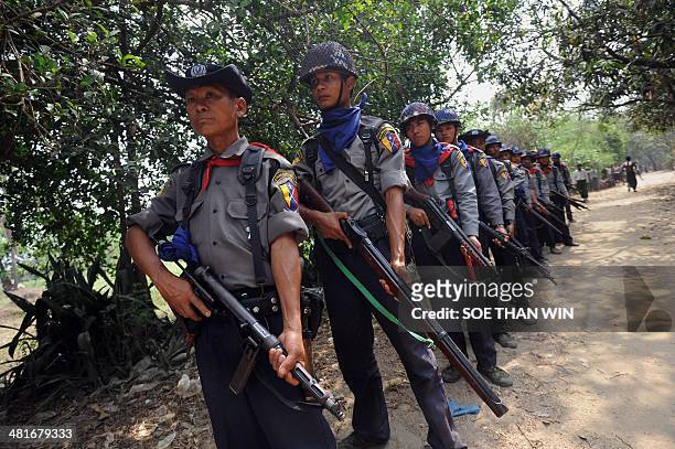 Myanmar police provide security during census taking in the village of Bumay on the outskirts of Sittwe in the western Myanmar state of Rakhine on...