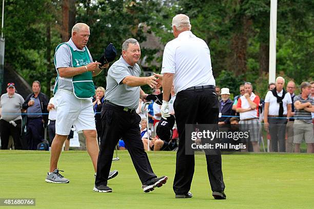 Ian Woosnam of Wales shakes hands with Sandy Lyle of Scotland during the first round of The Senior Open Championship played at Sunningdale Golf Club...