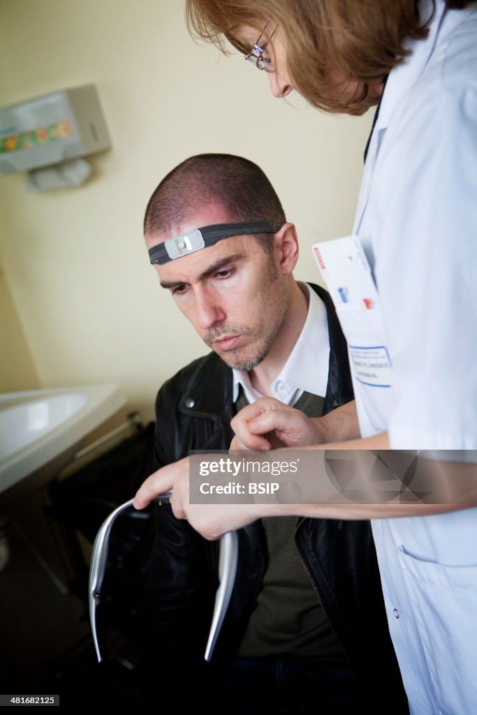 Reportage in the Pain Evaluation and Management Centre in Nantes hospital, France. They are specialised in the treatment of persistent chronic pain. A nurse places the Cefaly® on a patient. The device produces impulses that act on the Trigeminal nerv