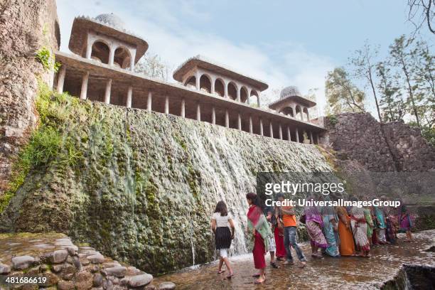 People enjoying in a waterfall at Rock garden by Nek Chand Saini, Rock Garden of Chandigarh, India.