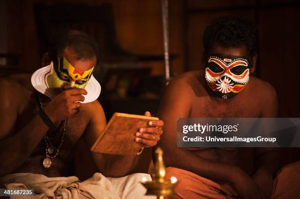 Men applying make-up for Kathakali performance, Kochi, Kerala, India.